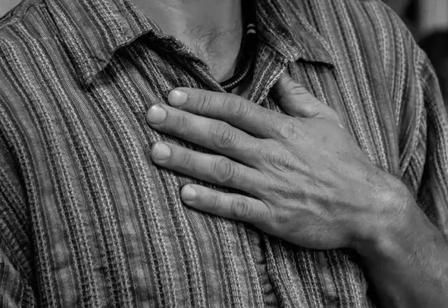 Man with hand on heart. We work as a community to heal trauma at the level of heart and soul.